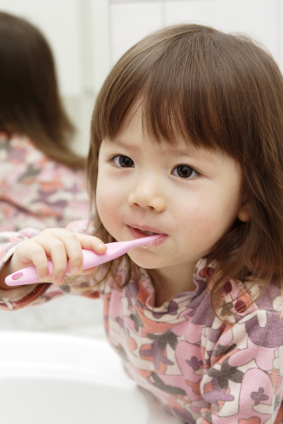 Little girl brushing her teeth