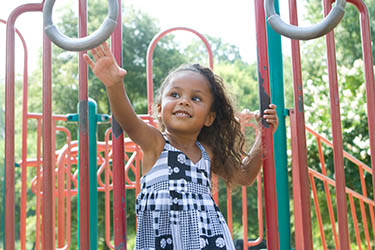 Girl playing on jungle-gym